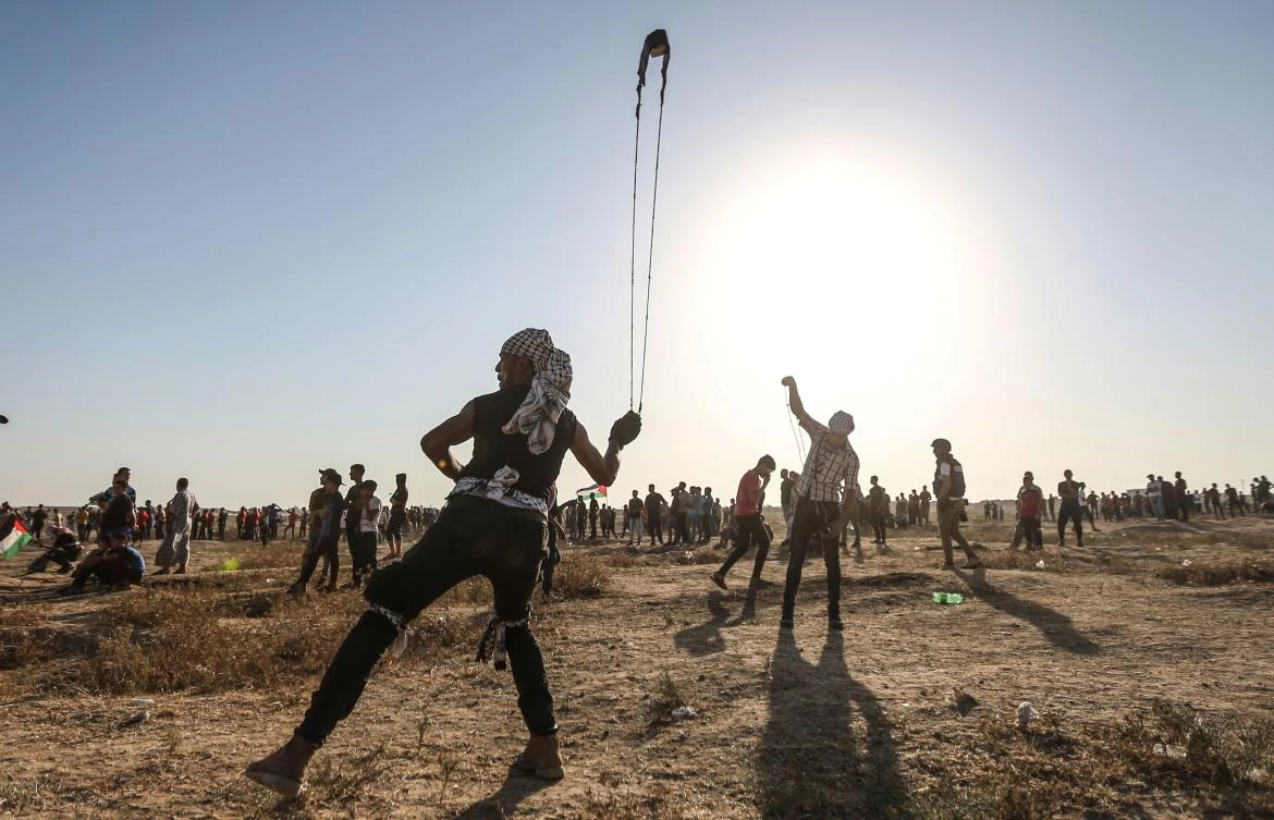 A Palestinian protester uses a slingshot to hurl stones during clashes with Israeli forces near the border with Israel in the eastern Gaza Strip on August 16, 2019. (AFP)