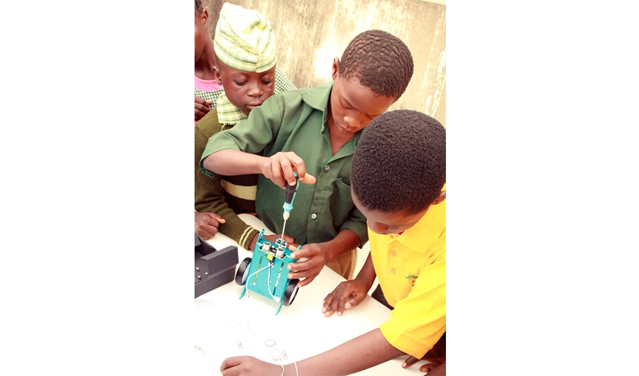 Students from primary schools across Apado Town participate in a workshop.
