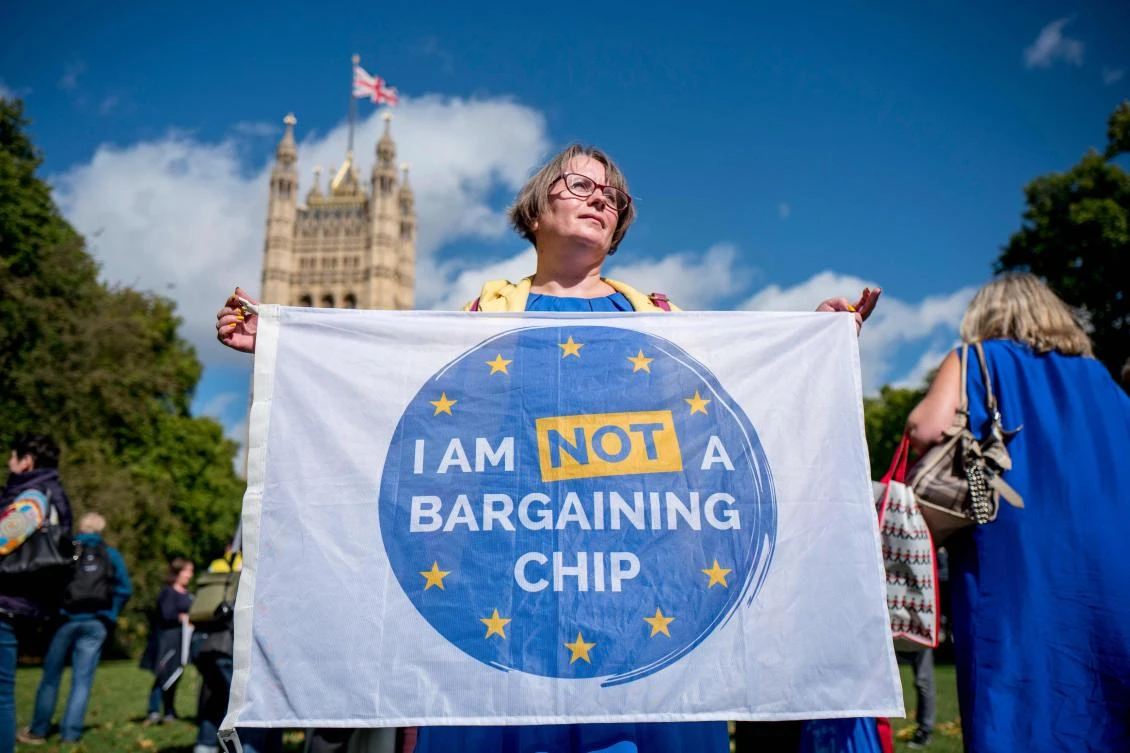 In this file photo taken on September 13, 2017 Demonstrators hold banners during a protest to Lobby MPs to guarantee the rights of EU citizens living in the UK, after Brexit, outside the Houses of Parliament in central London on September 13, 2017. (AFP)