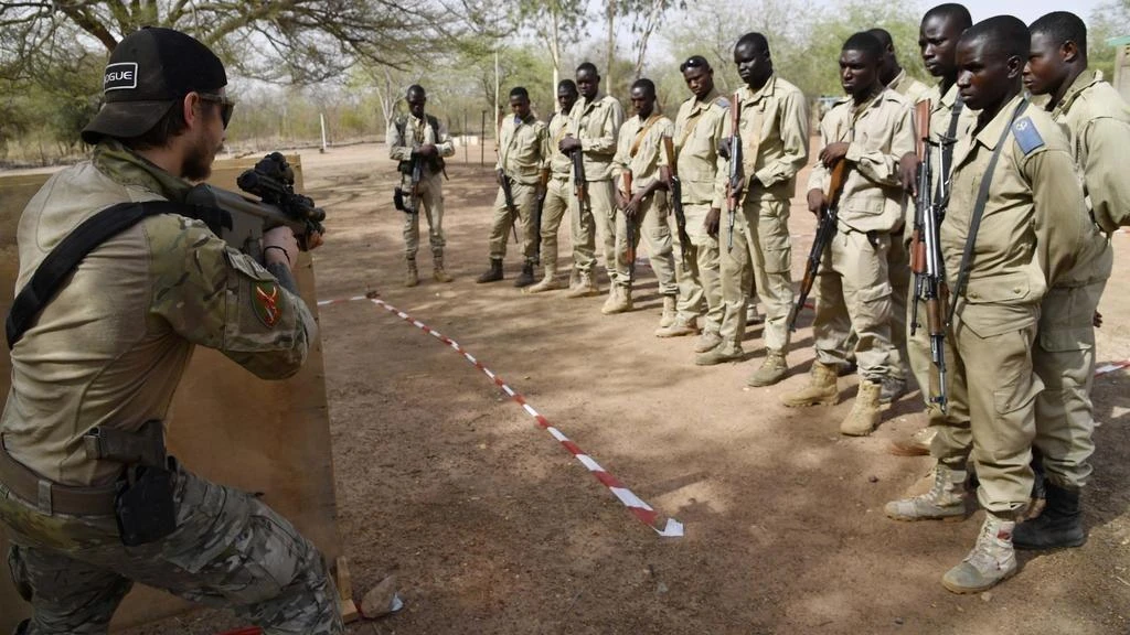 An Austrian army instructor, left, and Burkina Faso soldiers during a military anti-terrorism exercise near Ouagadougo. (AFP)