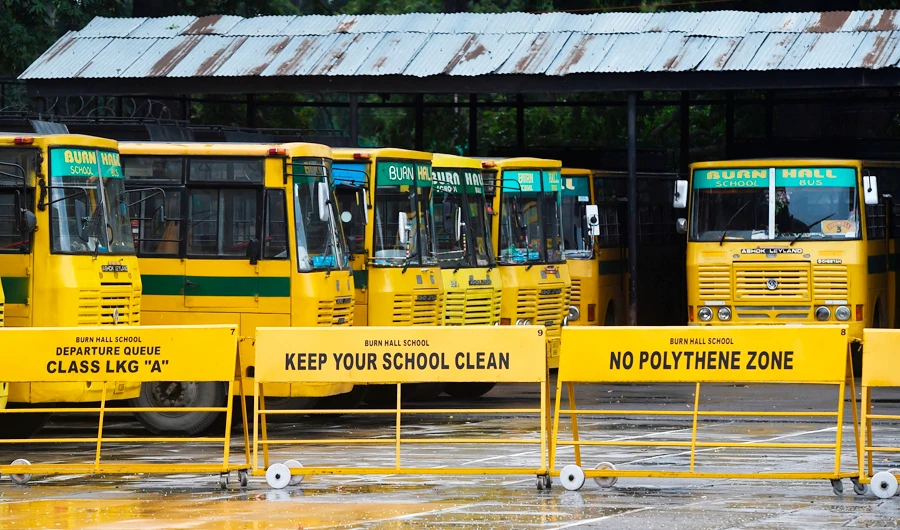 School buses are seen parked in the campus of a closed school in Srinagar on August 19, 2019. (AFP)