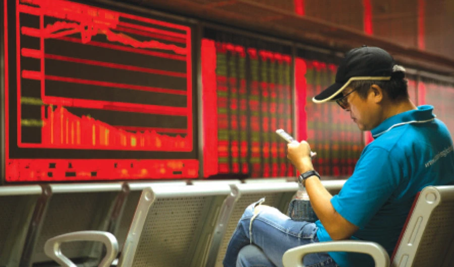 A Chinese investor monitors stock prices at a brokerage in Beijing. China has kicked off its interest rate reform program in an effort to lower corporate borrowing costs. (AP)