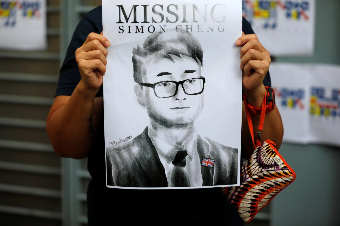 A woman holds a poster of Simon Cheng, a staff member at the consulate who went missing on Aug. 9 after visiting the neighboring mainland city of Shenzhen, during a protest outside the British Consulate-general office in Hong Kong, China, Aug. 21, 2019. (File/Reuters/Willy Kurniawan)