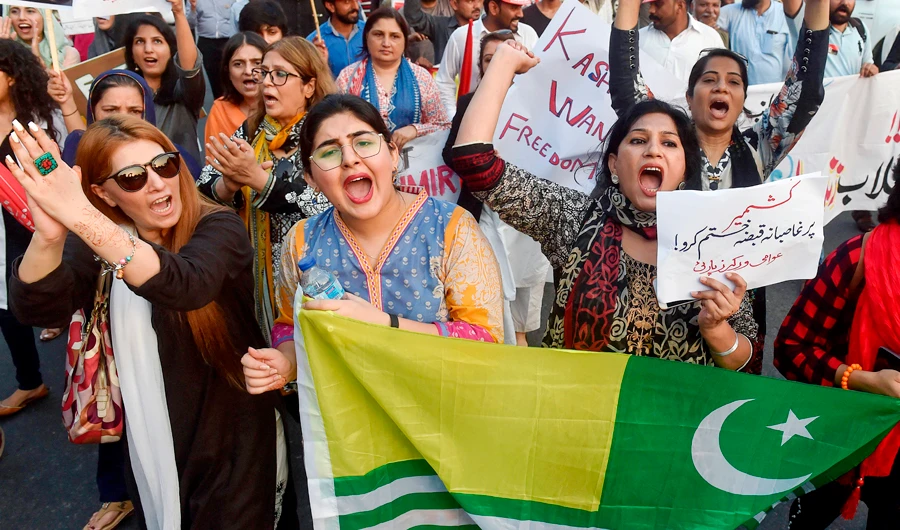 Pakistani civil society activists carry placards as they shout slogans during a protest rally in Lahore on August 20, 2019, as they condemn the India stripped the disputed Kashmir region of its special autonomy and imposed a lockdown two weeks ago. (AFP)