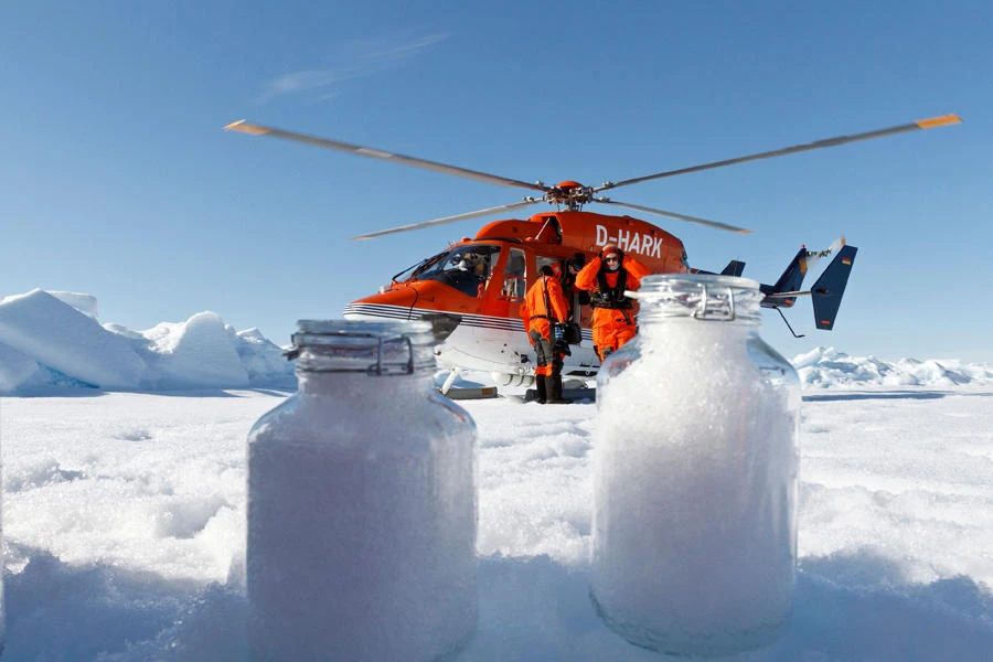 In this August 4, 2017, image courtesy of the Alfred Wegener Institute, scientists from the institute use the helicopter from the icebreaker research vessel Polarstern to collect snow samples in the Arctic. Minute microplastic particles have been detected in the Arctic and the Alps, carried by the wind and later washed out in the snow, according to a study that called for urgent research to assess the health risks of inhalation. (AFP / Kajetan Deja / Alfred-Wegener-Institute)