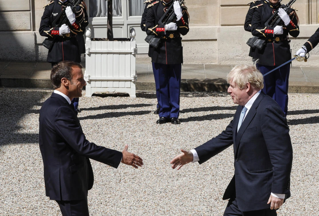 French President Emmanuel Macron (L) welcomes Britain’s Prime Minister Boris Johnson ahead of a meeting at The Elysee Palace in Paris on Aug. 22, 2019. (Geoffroy Van Der Hasselt/AFP)