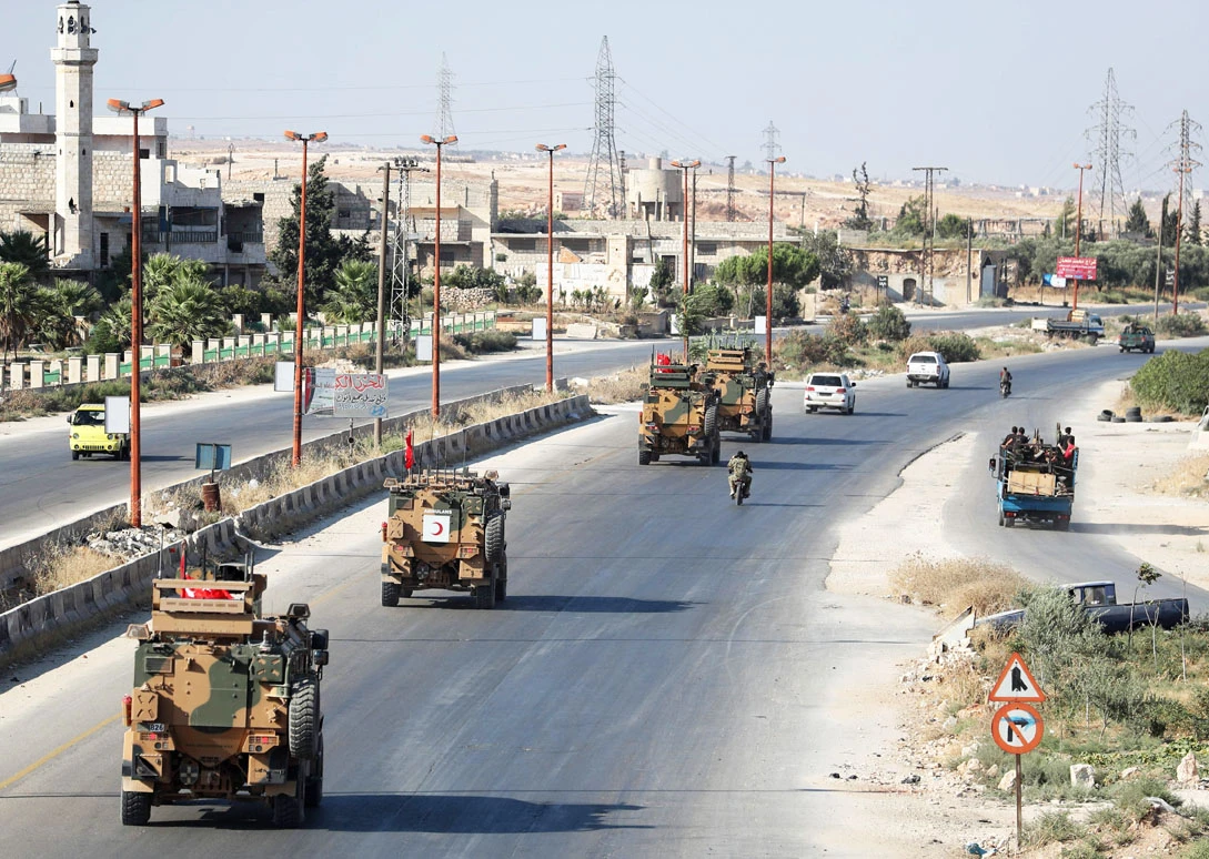 Turkish military vehicles pass through Maaret al-Numan in Syria's northern province of Idlib on August 22, 2019, heading back to Turkey after a reported two-day mission into Syria. (AFP / Omar Haj Kadour)