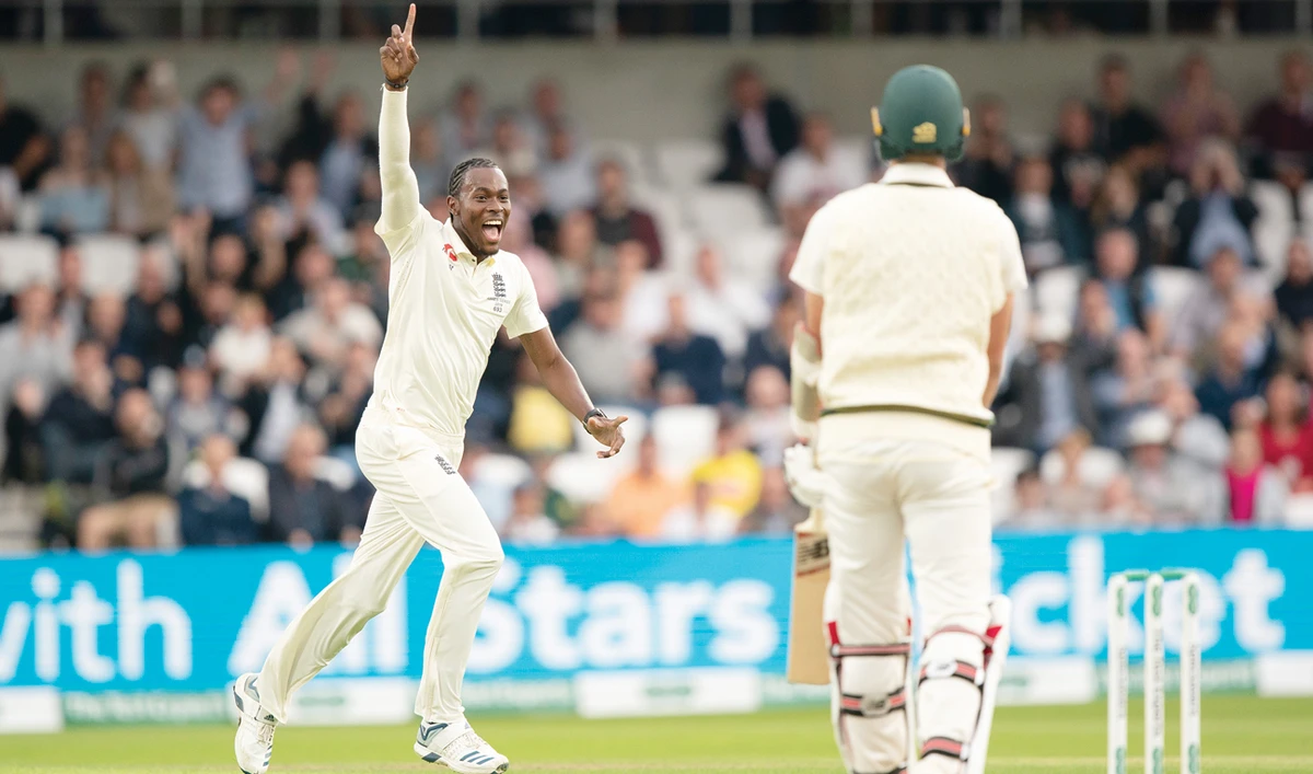 England's Jofra Archer celebrates after taking his fifth wicket, that of Australia's Pat Cummins, right, caught by Jonny Bairstow for 0. (AP)