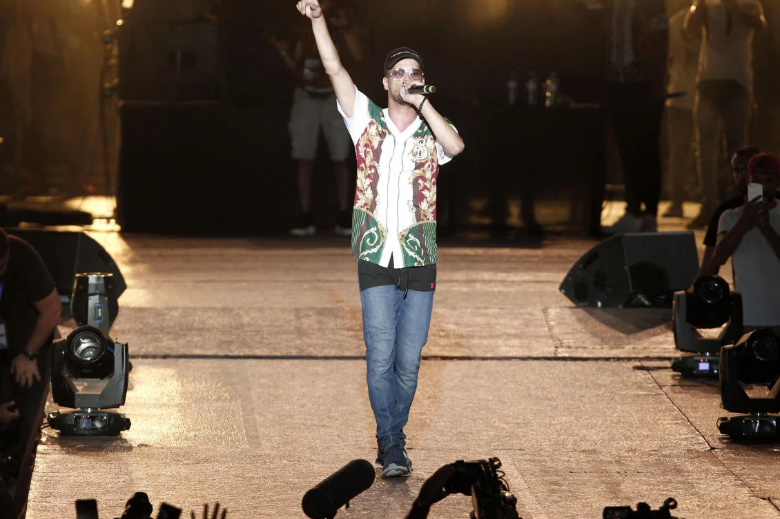 Algerian rap artist Abderraouf Derradji, known as Soolking, performs during a concert at a stadium in Algiers, Thursday, April 22, 2019. (AP)