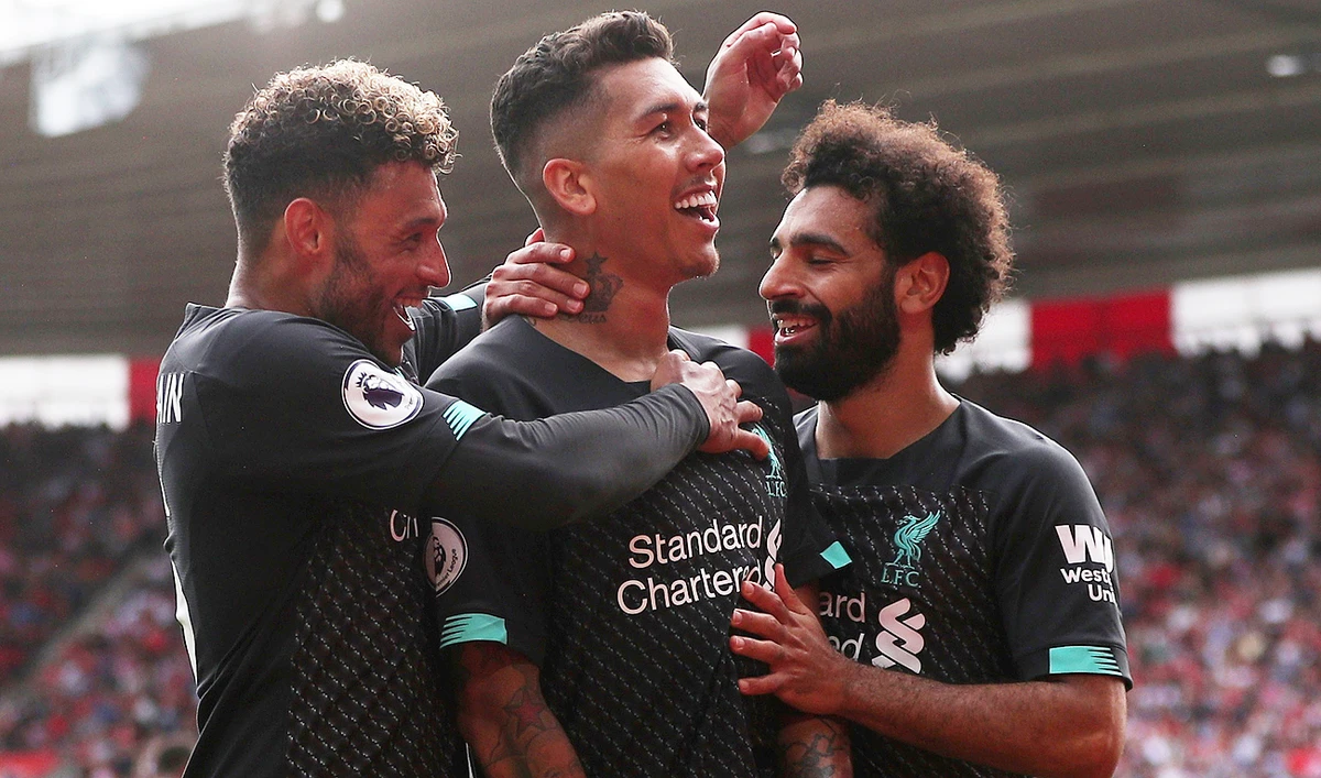 Liverpool's Roberto Firmino celebrates scoring their second goal with teammates Alex Oxlade-Chamberlain and Mohamed Salah. (Reuters)
