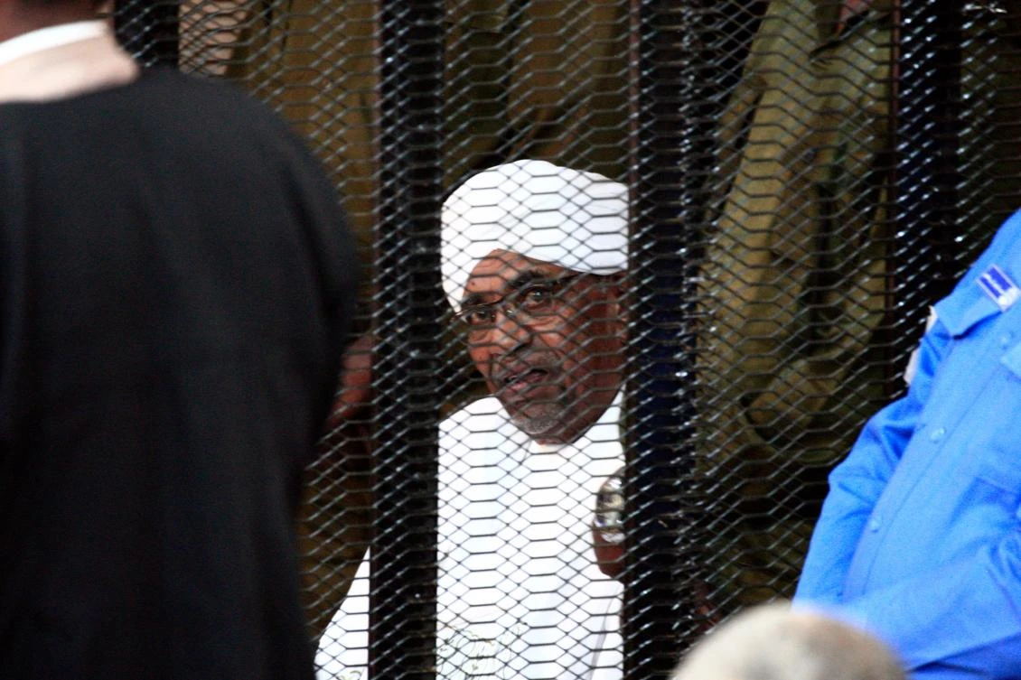 Sudan’s deposed military ruler Omar Al-Bashir sits in a defendant’s cage during his corruption trial in Khartoum on August 24, 2019. (AFP)