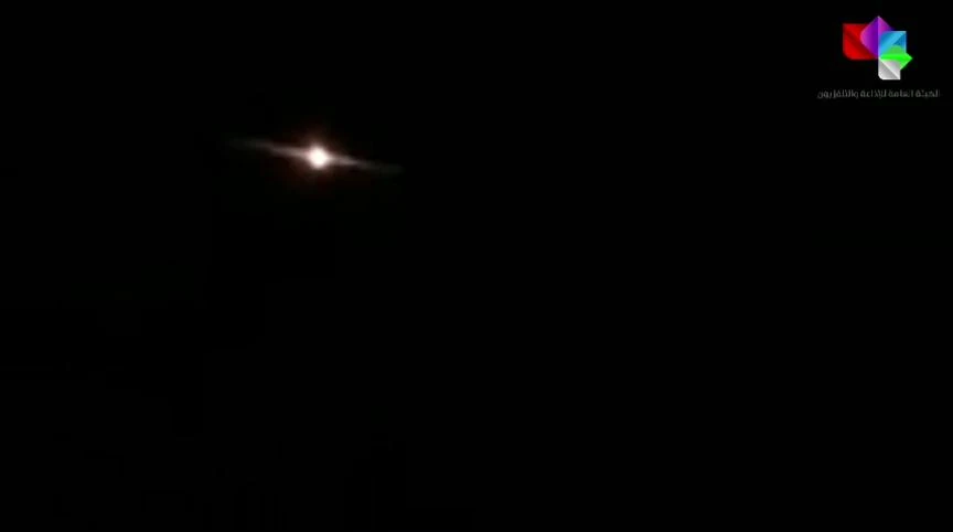 This image grab taken from a handout video released by the Syrian General Organization of Radio and Television late on August 24, 2019 shows lights in the sky reportedly over Aqraba, southeast of the Syrian capital Damascus during an Israeli air strike. (AFP)