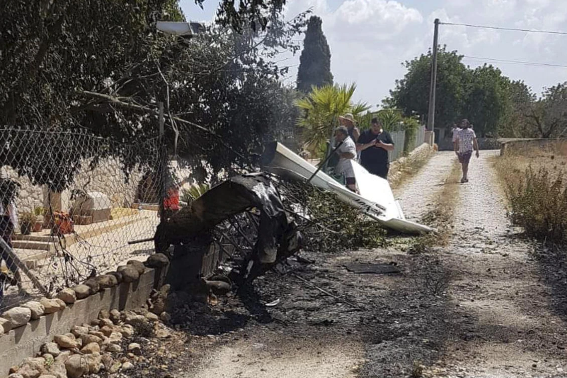 Wreckage on a path near Inca in Palma de Mallorca, Spain, a helicopter collided with a plane killing 5 people. (AP)