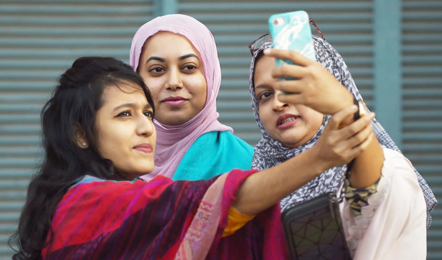 First time Bangladeshi voters take a selfie after casting their vote at a polling station in Dhaka on December 30, 2018. (AFP)