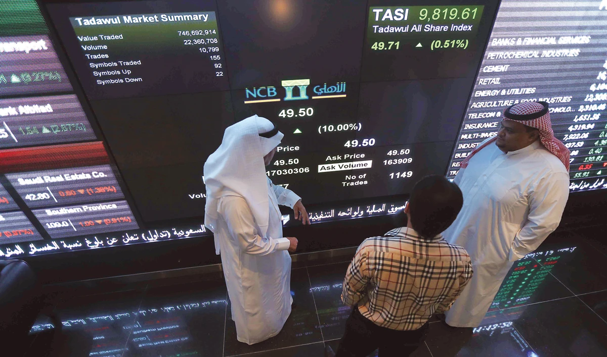 Saudi investors monitor stocks at the recently opened exchange market department at the National Commercial Bank in Riyadh. (AFP)