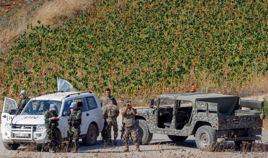 A picture taken from the Israeli side of the border with Lebanon on August 27, 2019 shows Lebanese army and United Nations Interim Forces in Lebanon (UNIFIL) vehicles patrolling in the Lebanese village of Aitaroun along the the Israeli side of the border with Lebanon i Lebanese border. (AFP / JACK GUEZ)
