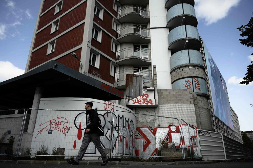 A man walks past a building of the Youri Gagarine quarter in Ivry-sur-Seine, on the outskirts of the French capital Paris on August 19, 2019.(AFP / Philippe Lopez)