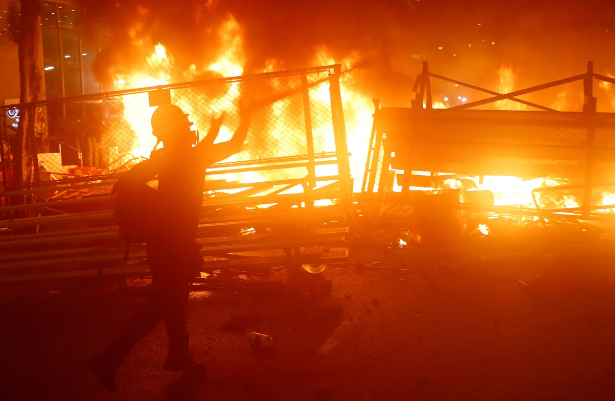A demonstrator stands next to a burning barricade during a protest in Hong Kong, China August 31, 2019. (Reuters)