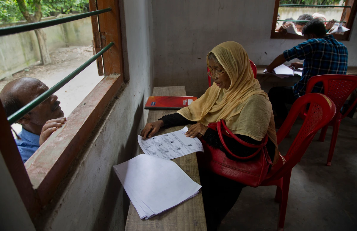 Villagers check for their names in the final list of the National Register of Citizens (NRC) at an NRC center in Assam, India on Saturday, Aug. 31, 2019. (AP)