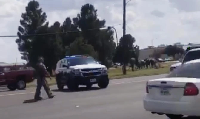 In this image made from video provided by Dustin Fawcett, police officers guard on a street in Odessa, Texas, on Aug. 31, 2019. (Dustin Fawcett via AP)