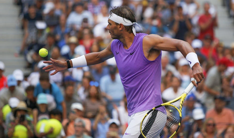 Rafael Nada hits autographed balls into the grandstand after defeating Hyeon Chung, of South Korea, during round three of the US Open tennis championships on Aug. 31, 2019, in New York. (AP Photo/Eduardo Munoz Alvarez)