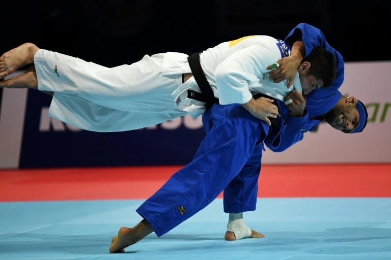 Iranian judo star Saeid Mollaei (in blue), who claimed he was ordered to deliberately lose a world championship fight, is seeking asylum in Germany. (AFP)