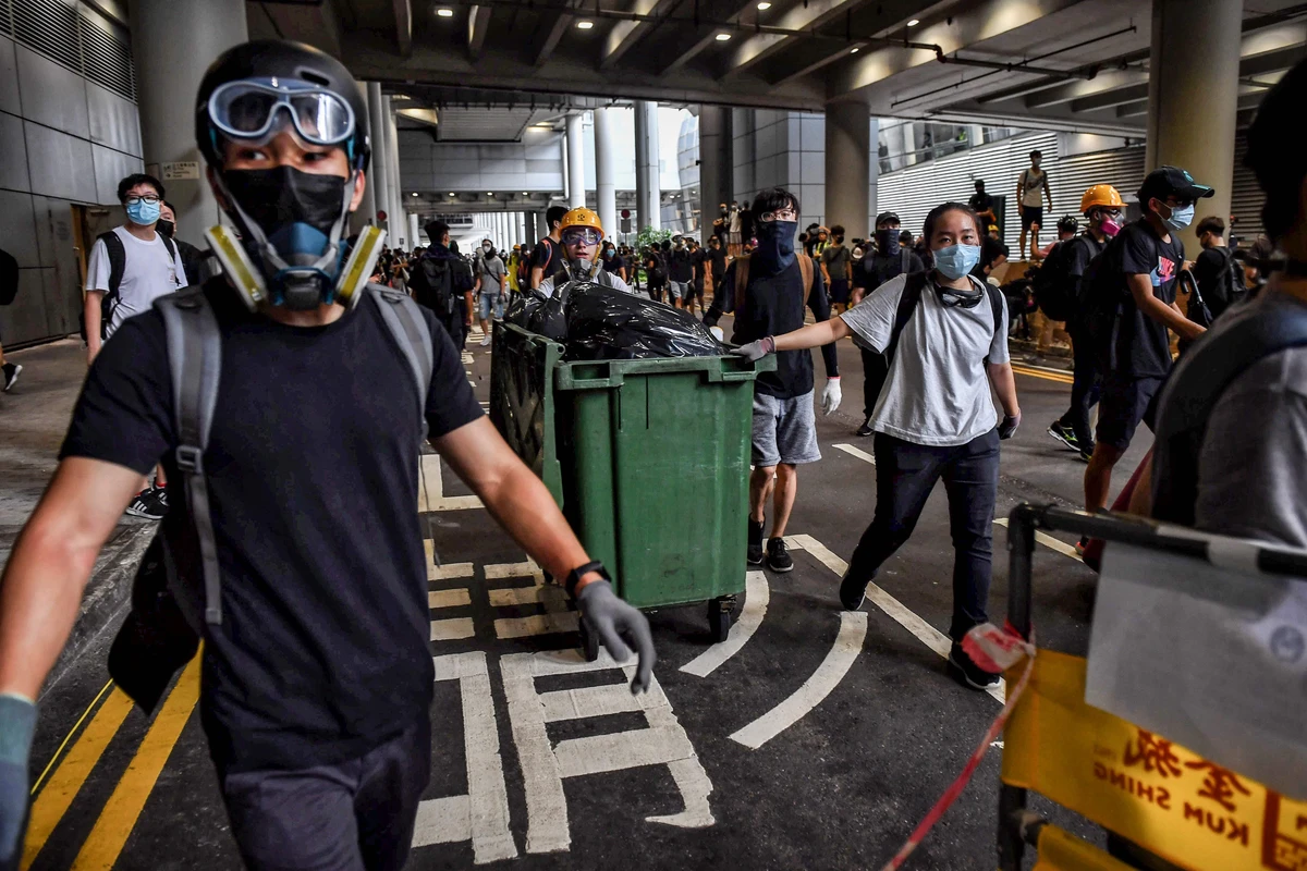 Protesters build barricades at Hong Kong International Airport on Sunday. (AFP)
