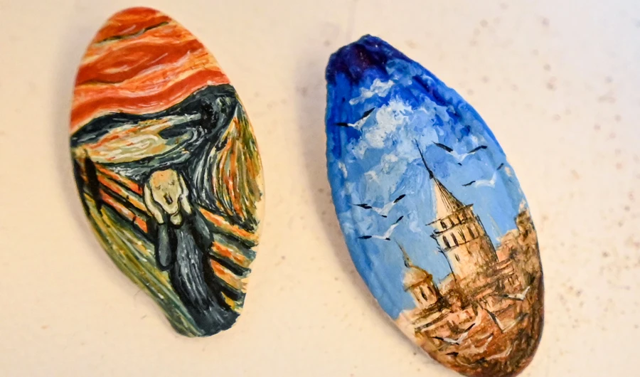 Paintings on pumpkin seeds by Turkey’s micro artist Hasan Kale in Istanbul. (AFP)