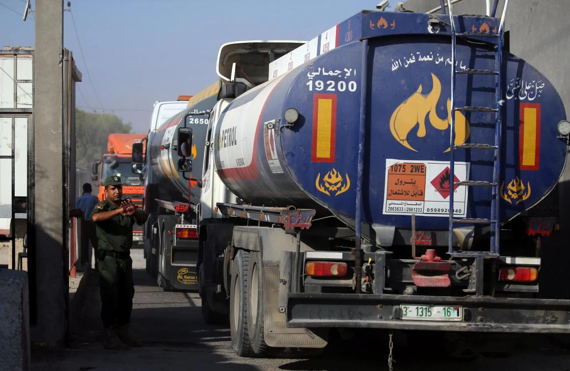 A member of the Palestinian security forces waves through a fuel tanker at the Kerem Shalom crossing, in Rafah, in the southern Gaza Strip. (Reuters)