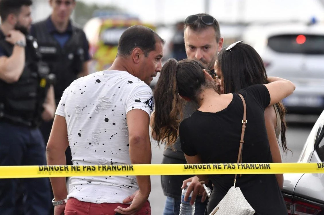 A witness to the knife attack is comforted by friends in Villeurbanne, southeastern France. (AFP)
