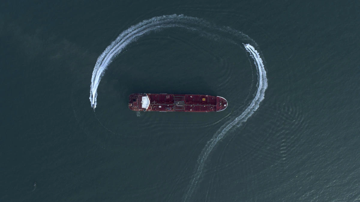 An aerial view shows a speedboat of Iran's Revolutionary Guard moving around the British-flagged oil tanker Stena Impero, which was seized in the Strait of Hormuz by the Guard, in the Iranian port of Bandar Abbas. (File/AP)