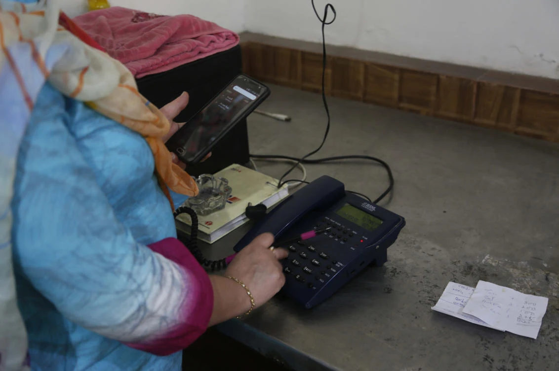 A Kashmiri woman makes a call to a relative after landline phones were restored in Srinagar, Indian controlled Kashmir, Thursday, Sept. 5, 2019. (AP)