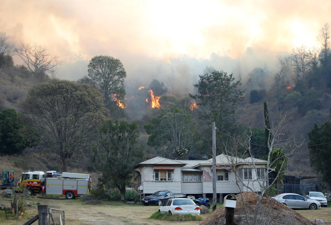 Fire and Emergency crew battle bushfire near a house in the rural town of Canungra in the Scenic Rim region of South East Queensland, Australia, Sept. 6, 2019. (Reuters)