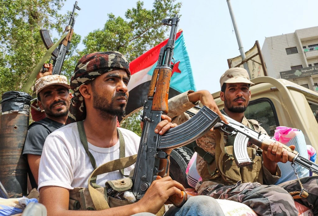 Fighters of the Southern Transitional Council, which seeks independence for south Yemen, sit with a southern separatist flag at the back of a pickup in Aden on August 29, 2019. (AFP)
