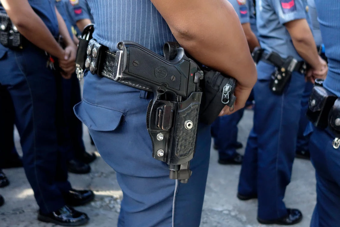 Police line up for a flag-raising ceremony outside a station in Quezon City Police District in Manila in April. (Reuters)