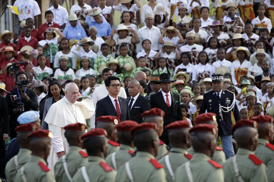 Pope Francis is flanked by Madagascar President Andry Rajoelina upon his arrival in Port Louis, Mauritius, from Antananarivo, Madagascar, Friday, Sept. 6, 2019. (AP)