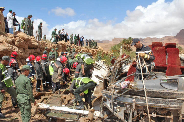 Members of the security forces search for bodies in the wreckage of bus at the banks of the Damchan river near the city of Errachidia, in the El Khank region in southern Morocco following a flood-related accident that left at least six people dead, on September 8, 2019. (AFP)