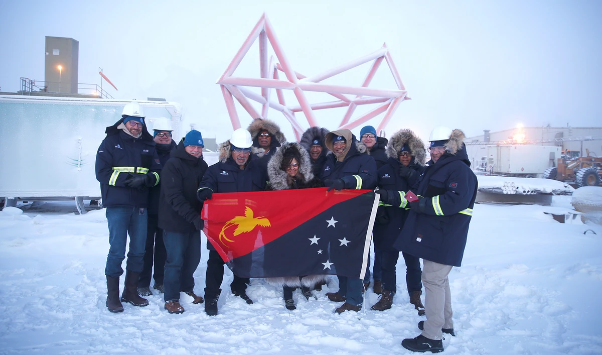 Participants pose for a photo with a Papua New Guinea flag during a stakeholder field trip to Oil Search facilities in Prudhoe Bay, Alaska. (Reuters)