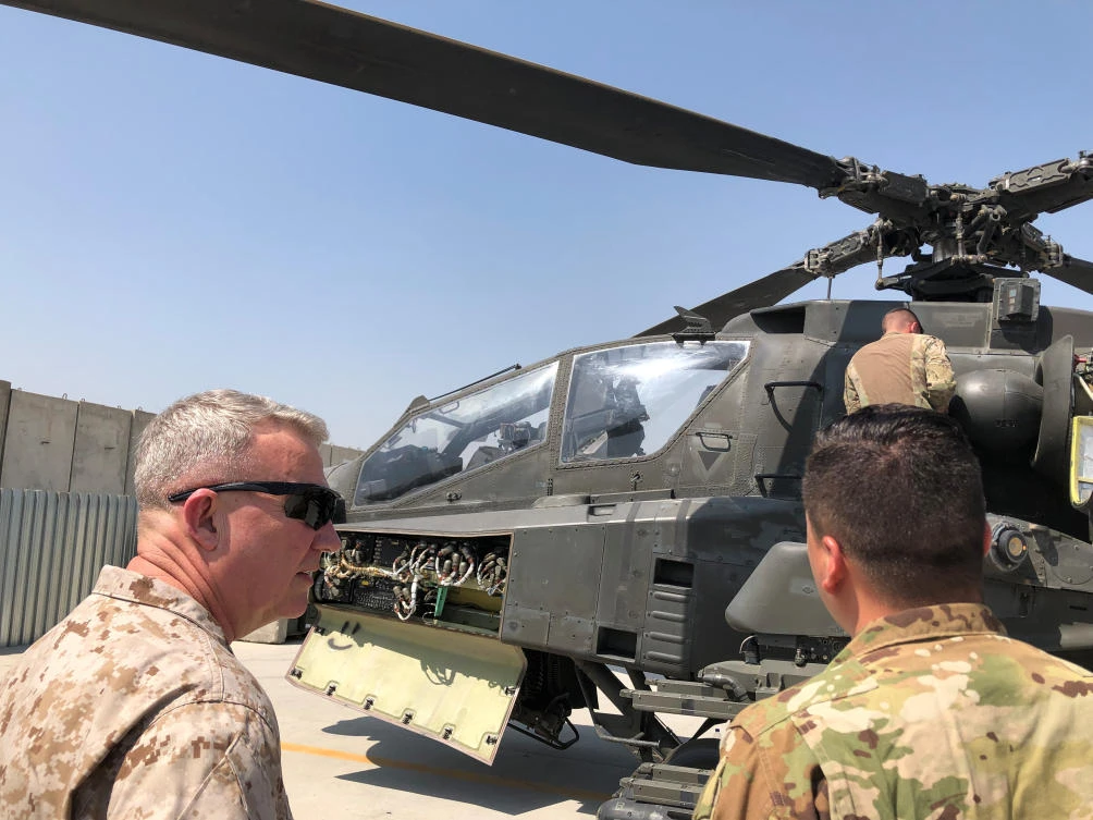 Marine Gen. Kenneth McKenzie, head of US Central Command, speaks with a US soldier as they stand in front of a US attack helicopter during a visit to Forward Operating Base Fenty in Jalalabad, Afghanistan. (Reuters)