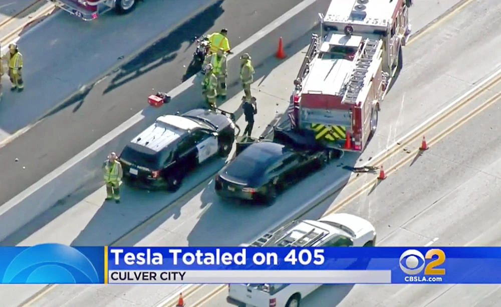 A government report says the driver of the Tesla that slammed into a firetruck was using the car's Autopilot system when a vehicle in front of him suddenly changed lanes and he didn't have time to react. (KCBS-TV via AP, File)