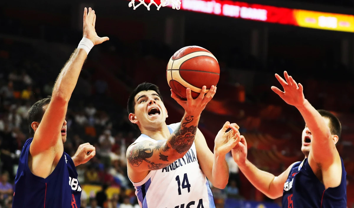 Argentina's Gabriel Deck tries to shoot past Serbia's Nemanja Bjelica at left and Serbia's Nikola Jokic during a quarterfinal match for the FIBA Basketball World Cup in Dongguan in southern China's Guangdong province on Tuesday, Sept. 10, 2019