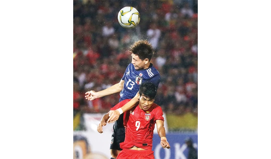 Myanmar's Thu Aung in action with Japan's Kento Hashimoto (top) during their Group A match. (Reuters )
