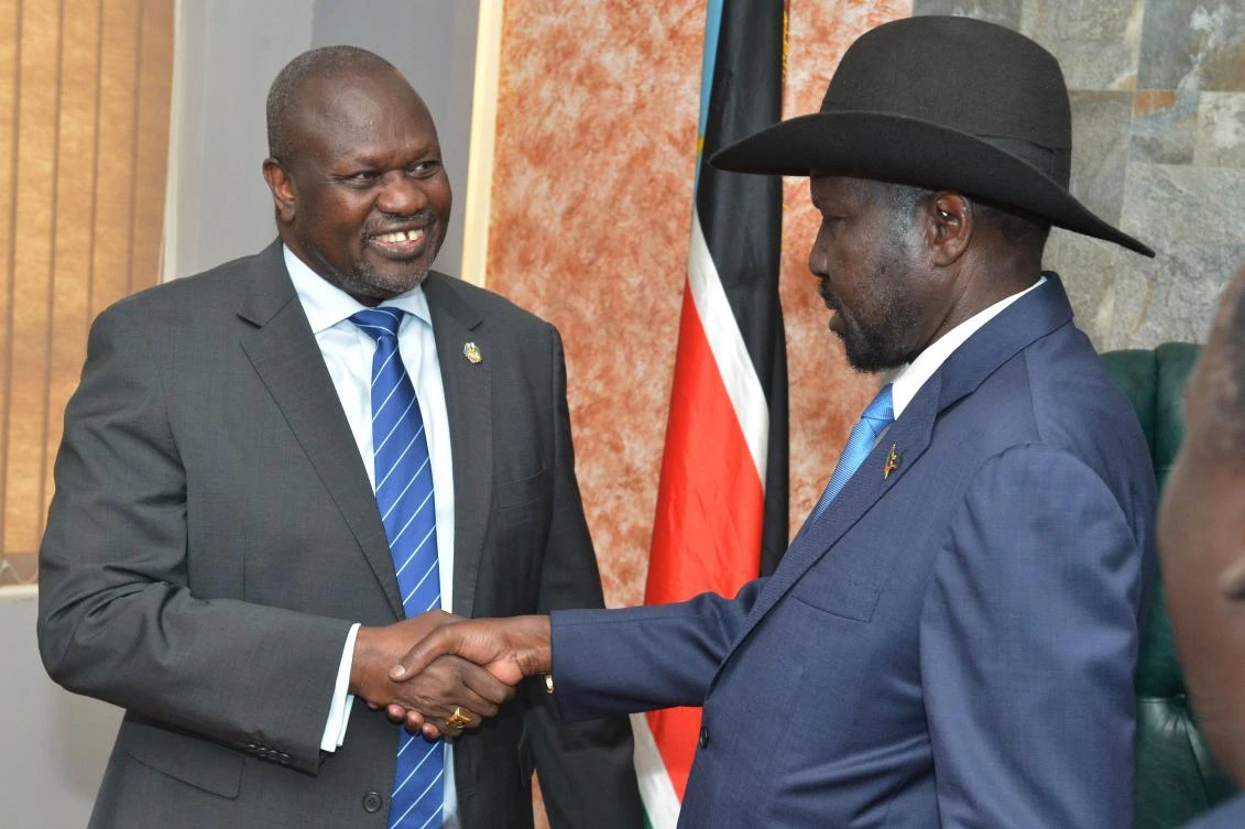 South Sudan's President Salva Kiir Mayardit (R) shake hands with ex-vice president and former rebel leader Riek Machar before their meeting in Juba, South Sudan, on September 11, 2019. (AFP)