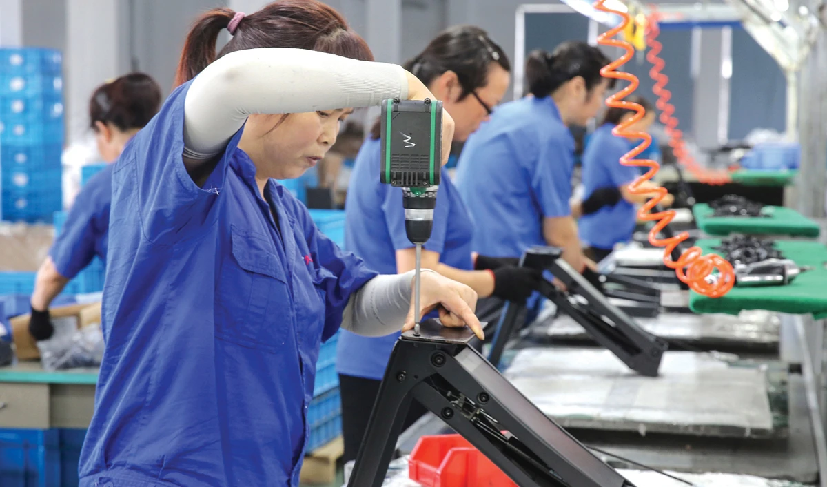 Workers make desks for export to the US at a factory in Nantong in China’s Jiangsu province. The world’s two largest economies have slapped tit-for-tat tariffs on hundreds of billions of dollars worth of goods. (AFP)