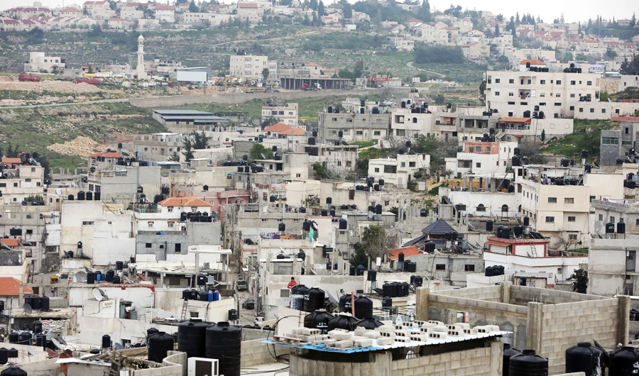 A picture taken on March 24, 2015 shows a general view of the Jalazon refugee camp north of the Israeli-occupied West Bank city of Ramallah, with the Jewish settlement of Bet El in the background. (AFP)