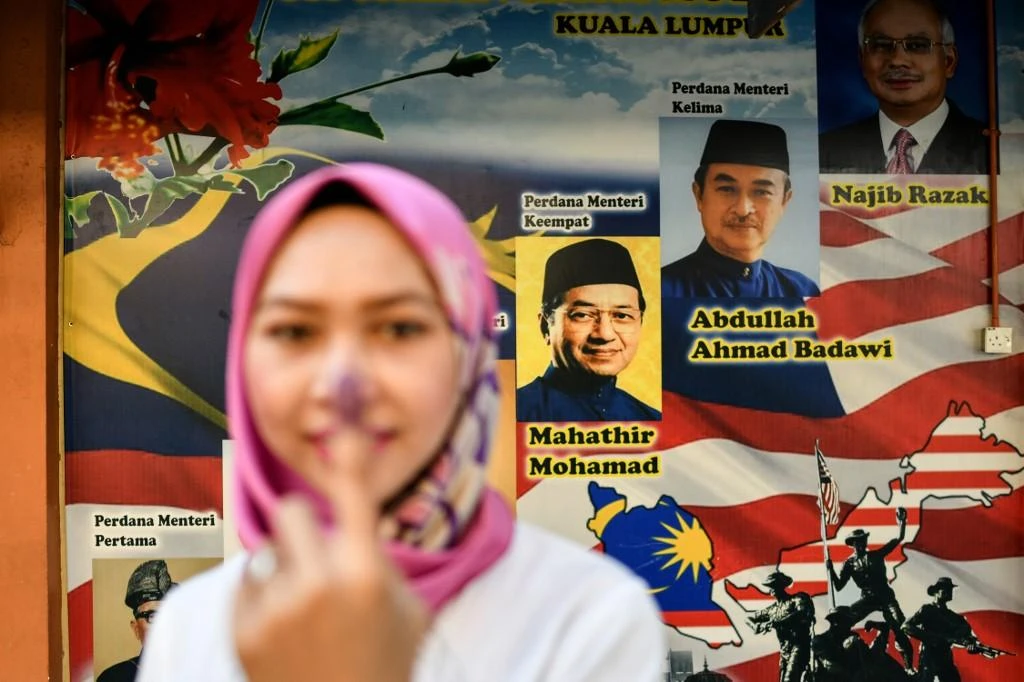A voter shows her inked finger during the 14th general election on May 9, 2018, which former prime minister Mahathir Mohamad won against incumbent Najib Razak. (AFP)