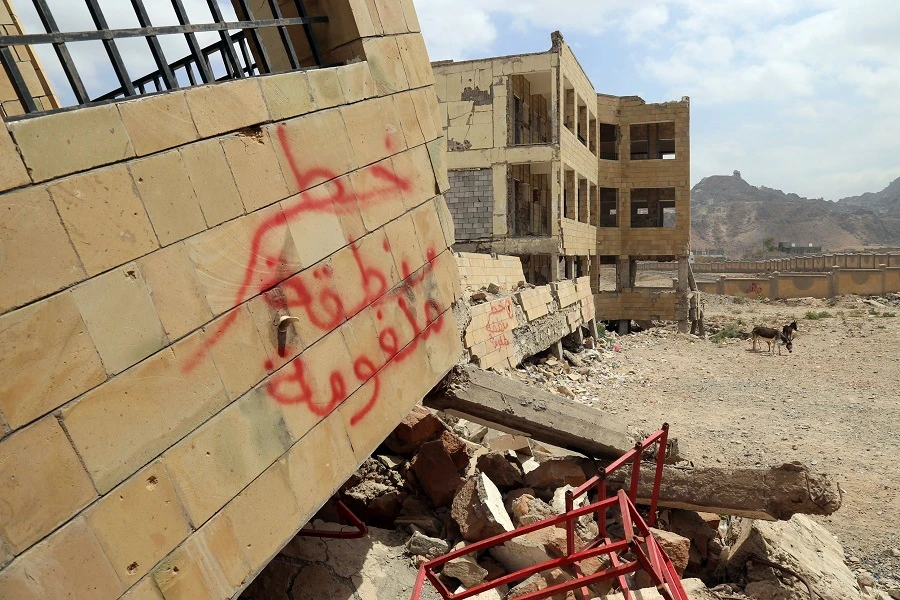 A note which reads in Arabic ‘Danger, landmines in area’ is painted on the debris of a school on March 6, 2019. (File/AFP)