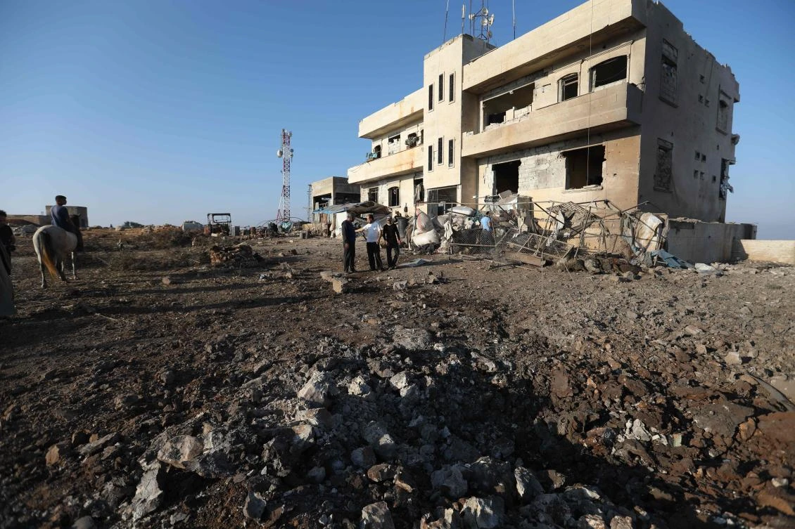 Onlookers gather at the scene of a reported Russian air strike in the village of Al-Daher in Syria’s northwestern Idlib on September 11, 2019. (AFP)