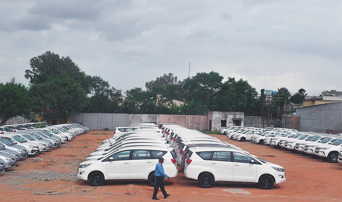 A security guard patrols a holding area for new vehicles near a godown on the outskirts of Hyderabad. (AFP)