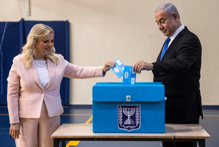 Israeli Prime Minister Benjamin Netanyahu and his wife Sara cast their votes at a voting station in Jerusalem on Sept. 17, 2019. (Heidi Levine/Pool/AFP)